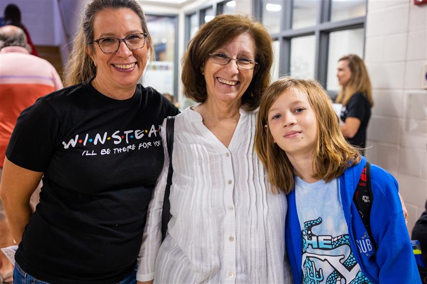 A family smiles at Winstead Elementary's Grandparents Breakfast